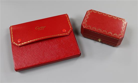 Two Cartier gilt tooled red leather jewellery boxes.